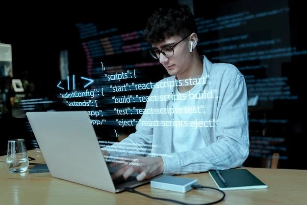 A developer coding on a laptop with digital code displayed on the screen.